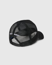 The Psycho Bunny KIDS BUNNY PATCH TRUCKER CAP (B0A965C200) is a black kids' hat with breathable mesh panels, an adjustable snapback, and "PSYCHO BUNNY" embroidered in white above the back opening.
