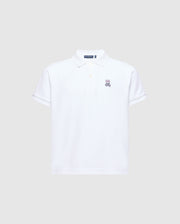 The Psycho Bunny Kids Classic Pique Polo Shirt (B0K001CRPC) is a white short-sleeved polo shirt made from soft Pima cotton. It features an embroidered rabbit logo on the left chest and has a classic collar with a button-up placket, all set against a light grey background.