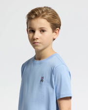 A young boy with light brown hair wears the KIDS CLASSIC CREW NECK TEE - B0U014B200 by Psycho Bunny, featuring a small embroidered Bunny logo, against a plain white background.
