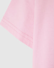 Close-up of the Psycho Bunny KIDS CLASSIC CREW NECK TEE - B0U014CRPC in pink, featuring visible sleeve stitching. Made from 100% Pima cotton for a soft and well-sewn finish, it's a high-quality choice perfect for back-to-school outfits.