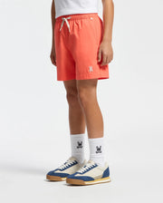 Clad in orange Psycho Bunny KIDS SAMOS HYDROCHROMIC PRINTED SWIM TRUNK - B0W453F200 with drawstring, logo-printed white socks, and blue-and-white sneakers against a plain backdrop, this chic look's lower half is on display. Made from quick-dry fabric, it blends style and functionality effortlessly.