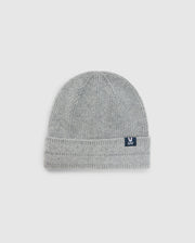 The MENS RACKED BEANIE - B6A188E200 by Psycho Bunny is a stylish and cozy gray knitted beanie crafted from warm Merino wool. It features a folded brim against a light background, adorned with a small black patch displaying the brand's white logo. Its ribbed texture runs vertically for added style and comfort.