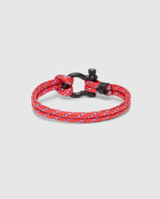 The Psycho Bunny MEN'S ROPE BRACELET - B6A368E200 is a stylish red and blue woven nylon rope bracelet featuring a versatile zinc alloy metal clasp.