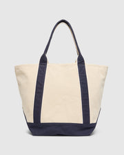The Psycho Bunny MENS GRAPHIC TOTE (B6A563F200) is a durable beige canvas tote with dark blue straps and bottom, perfect for functional carrying. It features two handles and a spacious design, set against a plain light gray background.