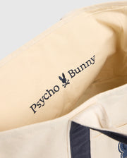 Close-up of the MENS GRAPHIC TOTE - B6A563F200 interior, showcasing the Psycho Bunny embroidered logo with a stylized bunny skull in dark stitching on light fabric, ideal for those seeking functionality-first haulers.