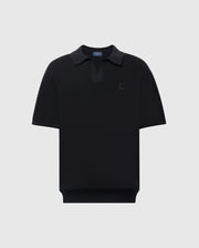 The Psycho Bunny MENS LEETON JOHNNY COLLAR KNIT POLO (B6E562F200) is a black, short-sleeve polo made from 100% cotton, featuring a subtle Bunny logo on the chest, dark collar, and breathable classic design against a light gray background.