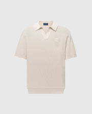 The Psycho Bunny MENS LEETON JOHNNY COLLAR KNIT POLO (B6E562F200) is a beige short-sleeve polo with a subtle V-neck collar, made from soft cotton. It features an embroidered logo on the left chest and offers a slim fit for a casual, classic style ideal for transitional dressing.
