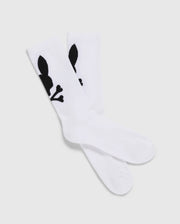 A pack of 3 Men's Sport Socks (B6F997D200) by Psycho Bunny, crafted from luxurious Peruvian Pima cotton in white, features a distinctive black graphic design of a skull with bunny ears and bones. The socks are displayed with one pair slightly overlapping the other on a plain, light-colored background.