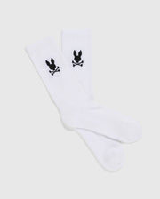 A set of 3 MENS 3 PACK SPORT SOCK - B6F997D200 by Psycho Bunny, showcasing a black skull and crossbones with bunny ears design near the top. These luxurious sport socks, crafted from Peruvian pima cotton, are displayed flat against a plain, light-gray background.
