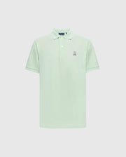 The Psycho Bunny Men's Classic Pique Polo (B6K001F200) in light green Pima cotton features a collar, short sleeves, and an embroidered Bunny logo with crossbones on the left chest against a plain white backdrop.