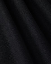 Close-up of a Pima cotton polo fabric with a slightly textured surface and folds. The solid pattern material appears soft, and the folds create subtle shadow variations, enhancing the depth and texture of the MENS EAST HILLS JOHNNY COLLAR POLO SHIRT - B6K331B200 by Psycho Bunny.