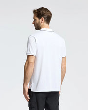 A man stands against a plain background in a Psycho Bunny MENS BRYCE PERFORMANCE PIQUE POLO (B6K486F200) and black cargo pants. He faces away, looking to the side, with neatly styled short hair enhancing his sleek look.
.