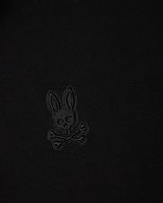 A black fabric featuring a stitched design of Psycho Bunny’s iconic skull with bunny ears and crossbones, all in a slightly different shade of black for subtle contrast – reminiscent of the stylish MENS MALTON PIQUE POLO SHIRT by Psycho Bunny (B6K950D200).