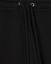 Close-up of black drawstrings on a black garment, likely the Psycho Bunny Men's Pacific Chenille Jogger (B6P972D200), featuring metal eyelets at the top. The fabric appears thick and textured, providing a casual bottom look ideal for everyday wear.