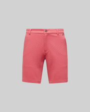 The Psycho Bunny MENS SHIRO KNIT HONEYCOMB SHORT - B6R585F200 features belt loops, a button closure, and side pockets in pink honeycomb-patterned piqué, shown on a plain light grey background.