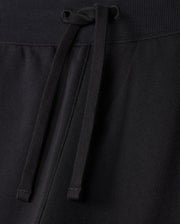 Close-up image of MENS LEVY FLEECE SWEATSHORT - B6R862D200 by Psycho Bunny, showcasing a black sweatshort with a drawstring waistband. The cozy french terry fabric texture is visible, emphasizing the casual and regular fit design. The strings are tied loosely in the center.