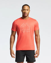 A man stands against a plain background wearing a bright orange Psycho Bunny MENS MELBOURNE GRAPHIC TEE - B6U410F200 made from eco-friendly Pima Cotton, featuring a bunny emblem. He pairs it with black shorts, arms relaxed by his sides, confidently facing the camera.