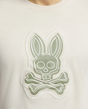 Close-up of the MENS SYDNEY GRAPHIC TEE by Psycho Bunny, featuring a stylized bunny with a skull face and crossbones, expertly outlined in gray and white. This edgy Pima cotton shirt embodies graphic print flair.