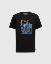 The Psycho Bunny MENS ZEALAND GRAPHIC TEE (B6U604F200) is a black t-shirt with a blue geometric bunny head and crossbones graphic on the chest, shown against a light gray background.
