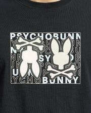 The Psycho Bunny MENS GOLD COAST GRAPHIC TEE - B6U631F200 is a black, premium Pima cotton shirt featuring a graphic bunny silhouette with crossbones over "PSYCHO BUNNY" text, offering style and classic fit comfort.
