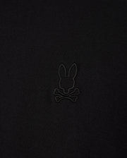 Close-up of the Psycho Bunny MENS JAMES PREMIUM CREW NECK TEE (B6U952D200), crafted from soft Pima cotton, featuring a black embroidered bunny head above crossbones logo, offering a playful twist on the traditional skull and crossbones symbol in the center.