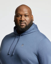 A man with a bald head and full beard confidently models the Psycho Bunny MENS BIG AND TALL LEVY ESSENTIAL FLEECE HOODIE - B9H859D200, made from 100% cotton, against a plain light background.
