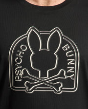 Close-up of the MENS BIG AND TALL MELBOURNE GRAPHIC TEE crafted from Peruvian Pima cotton. This black Psycho Bunny T-shirt features an eco-friendly, large graphic of a rabbit head above crossed bones with "Psycho Bunny" encircling the design.