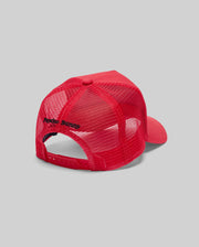 The KIDS GLENN TRUCKER CAP (KO1500012) by Psycho Bunny is shown from the back, featuring a red mesh design, adjustable snapback closure, and "Psycho Bunny" embroidered in black. Set against a plain light gray background.