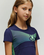 A girl poses for a picture wearing the Psycho Bunny RETAIL BALL CREW GIRLS DRESS (FR) - KO2000004.
