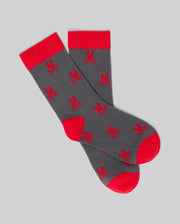 Psycho Bunny KIDS 2 PACK ALL OVER BUNNY DRESS SOCK - KO2200003: Gray Pima cotton socks with red heels, toes, and cuffs, featuring repeated red bunny patterns on a plain gray background.