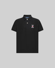 The Psycho Bunny KIDS MISCHIEF BUNNY PIQUE POLO (KT0100018) is a black, short-sleeve collared shirt with two mother-of-pearl buttons and a white and pink bunny skull logo on the left chest, shown on a light gray background.