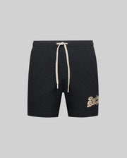 The Psycho Bunny MENS ELIAS SWIM TRUNK (MB1000008) features a classic fit, white drawstring, and beige cursive logo on the left leg, inspired by gym shorts and shown on a plain gray background.