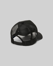 The Psycho Bunny MENS RYDER TRUCKER CAP (MO1500030) in black mesh and cotton twill is shown from the back, featuring an adjustable snapback closure and curved brim against a plain gray background.