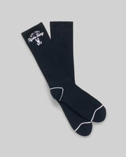 The Psycho Bunny MENS 3 PACK SPORT SOCK (MO2200006) features black knee-high socks with white trim, embroidered text, and a bunny logo near the top. Made from soft Pima cotton, they're displayed on a plain light gray background.