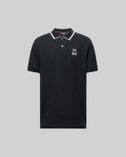 The Psycho Bunny MENS JUDE PIQUE POLO (MT0100012) is a black short-sleeve shirt with white trim on the collar and sleeves, an embroidered bunny logo on the left chest, and is made from soft Pima cotton for comfort. Displayed on a light gray background.