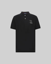 The Psycho Bunny MENS CYRUS PIQUE POLO - MT0100056 is a black Pima cotton polo with short sleeves, a three-button collar, and a white embroidered cartoon bunny outline on the left chest, shown on a plain light gray background.