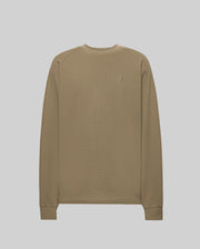 The Psycho Bunny MENS EVANS WAFFLE (MT0200091) features a plain, long-sleeved, light brown cotton knit crew neck, ribbed cuffs, and a small embroidered Bunny logo on the left chest, shown against a plain light background.