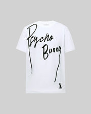 The MENS SOREN GRAPHIC TEE - MT0200180 by Psycho Bunny is a white 100% cotton tee with "Psycho Bunny" in bold, flocked diagonal letters and a small bunny logo with crossbones at the bottom right, set against a light gray background.