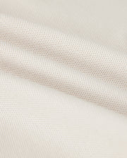 A close-up shows the Psycho Bunny MENS CLASSIC PIQUE POLO SHIRT - B6K001B200, with a textured weave pattern. The soft white fabric resembles fine Pima cotton, with subtle shadowing in the folds that exude timeless men's fashion.