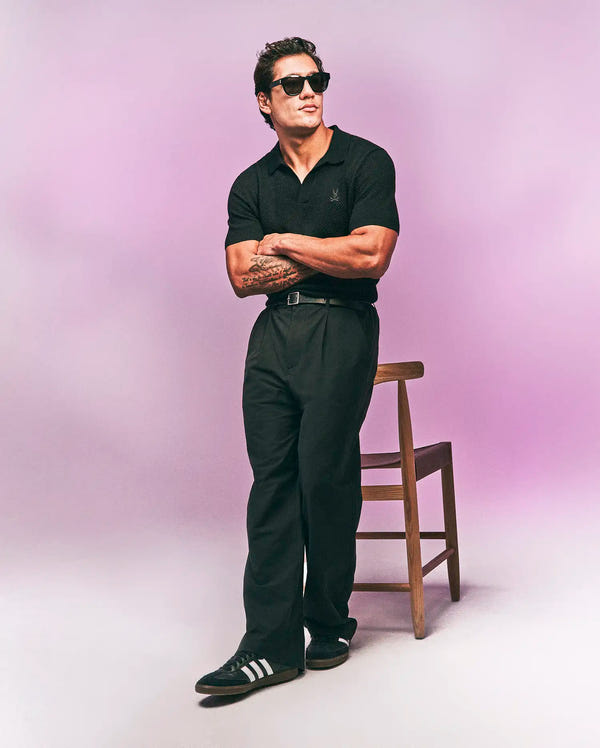 Mens Devon Knit Polo in black, featuring a textured knit fabric, classic fit, and a small, tonal embroidered Psycho Bunny skull logo on the left chest.