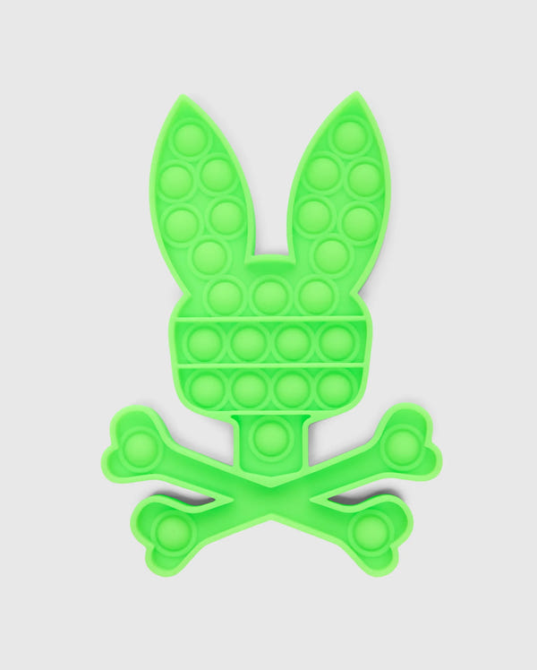 Introducing the PSYCHO BUNNY POP IT - B0A376E200 by Psycho Bunny, a premium silicone fidget toy designed in the shape of a bunny head above a crossbones, set against a white background.