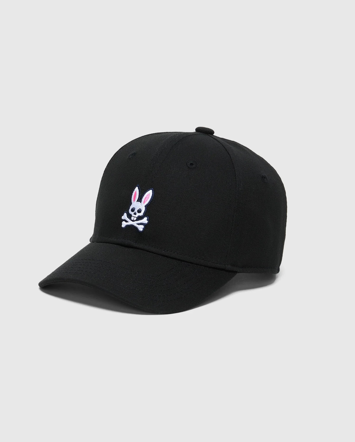 The KIDS CLASSIC BASEBALL CAP - B0A816A1HT by Psycho Bunny features a black color with an embroidered bunny and pink-eared skull and crossbones on the front. It offers an adjustable fit and is set against a plain gray background for a stylish look.