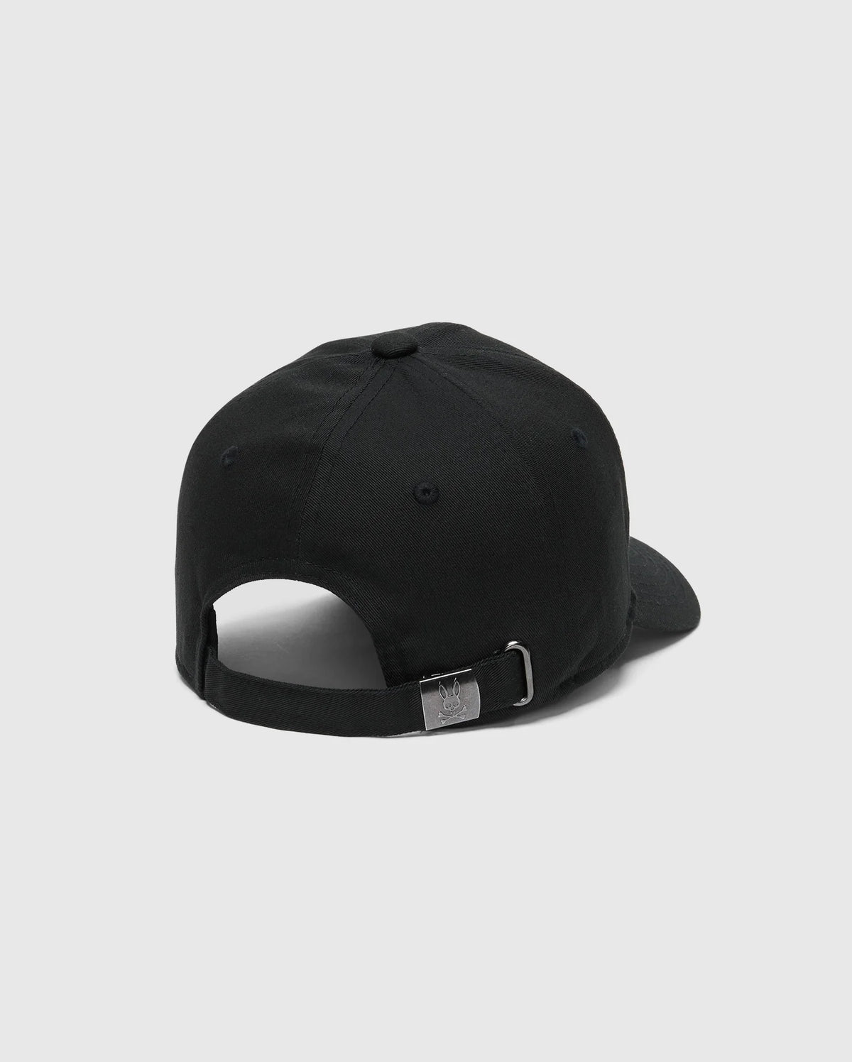 The image shows the back of a KIDS CLASSIC BASEBALL CAP - B0A816A1HT by Psycho Bunny in black, featuring an embroidered Bunny design, adjustable fit, strap, and silver buckle on a plain white background.