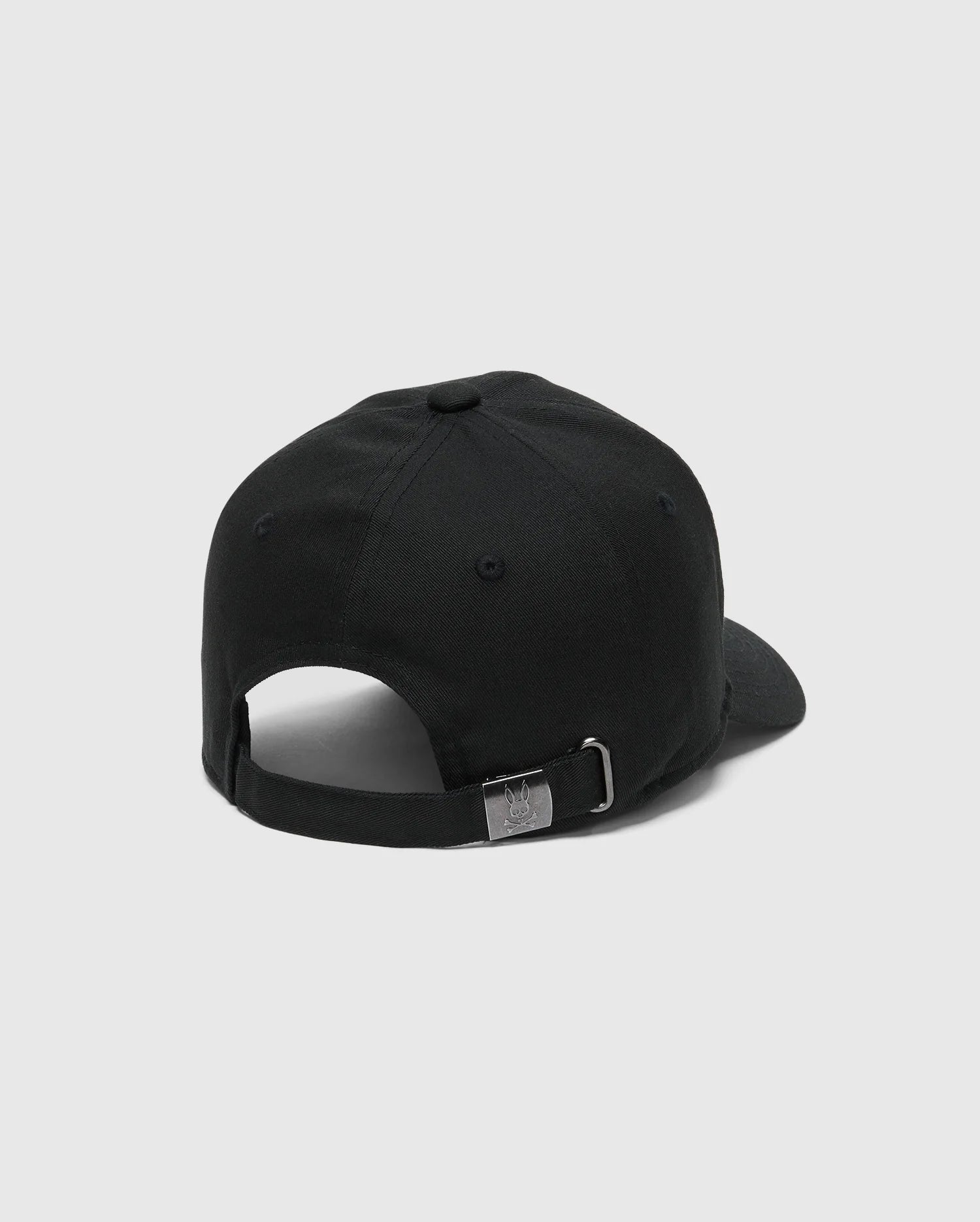The image shows the back of a KIDS CLASSIC BASEBALL CAP - B0A816A1HT by Psycho Bunny in black, featuring an embroidered Bunny design, adjustable fit, strap, and silver buckle on a plain white background.