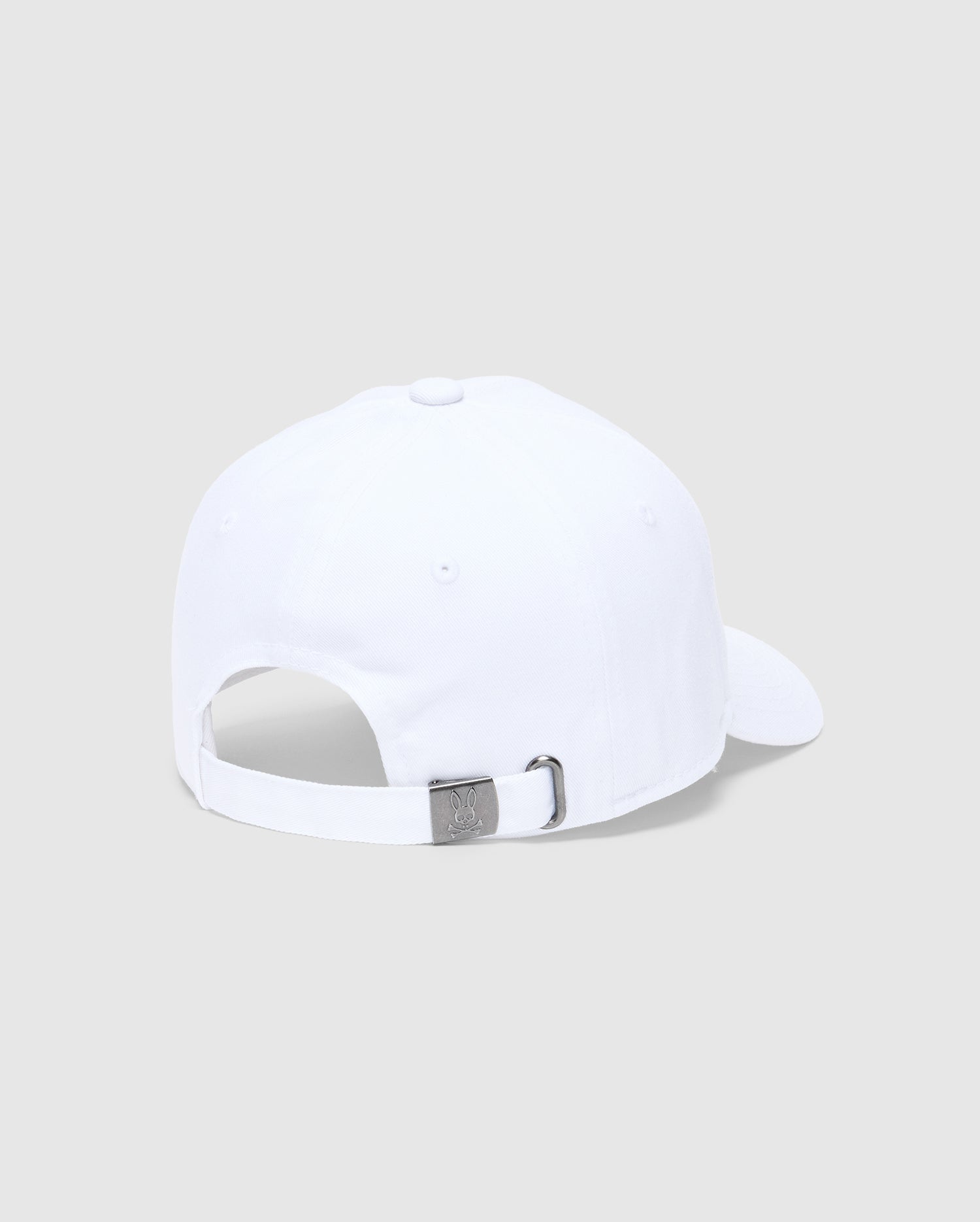 The KIDS CLASSIC BASEBALL CAP - B0A816A1HT by Psycho Bunny features a white cap with an adjustable silver buckle and an embroidered Bunny logo. With its back facing the viewer and set against a light gray background, this piece exudes timeless style and practicality.