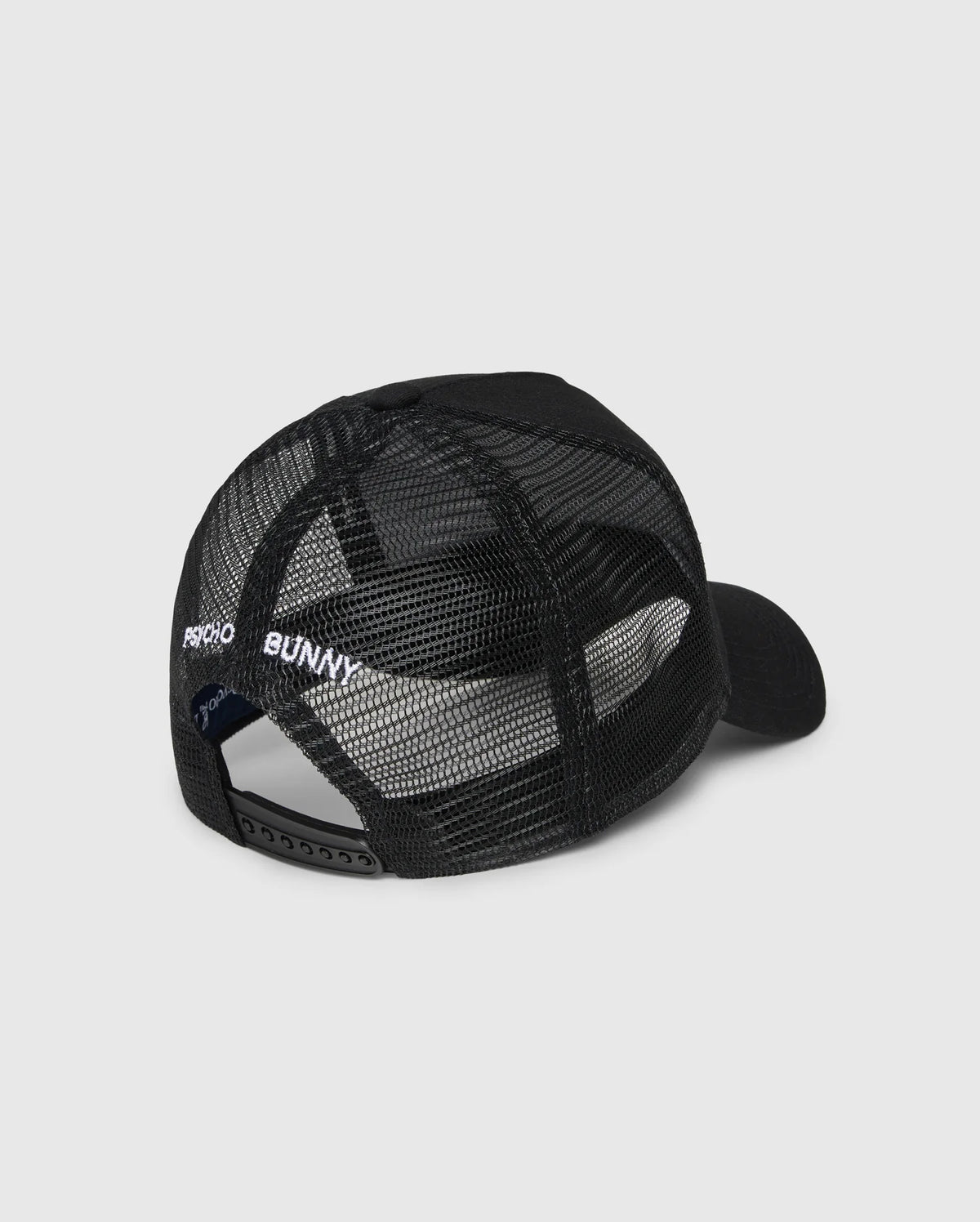 The Psycho Bunny KIDS BUNNY PATCH TRUCKER CAP (B0A965C200) is a black kids' hat with breathable mesh panels, an adjustable snapback, and "PSYCHO BUNNY" embroidered in white above the back opening.