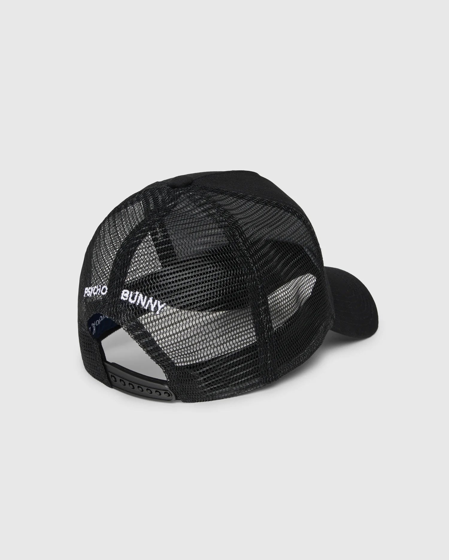 The Psycho Bunny KIDS BUNNY PATCH TRUCKER CAP (B0A965C200) is a black kids' hat with breathable mesh panels, an adjustable snapback, and "PSYCHO BUNNY" embroidered in white above the back opening.