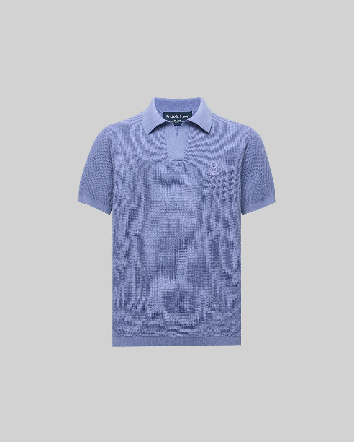 The Psycho Bunny KIDS LEETON JOHNNY COLLAR KNIT POLO (B0E562F200) is a light purple cotton sweater polo with a Johnny collar, short placket, and embroidered logo on the chest, shown against a plain light gray background.