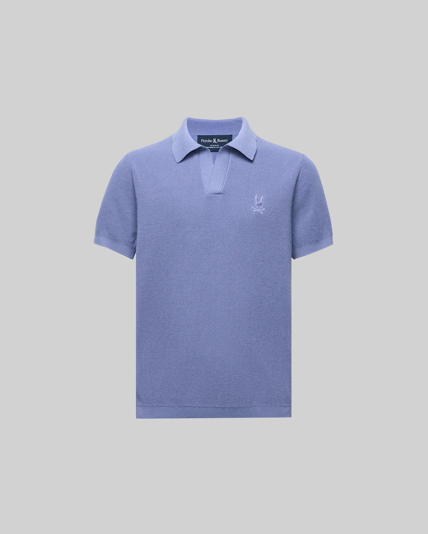 The Psycho Bunny KIDS LEETON JOHNNY COLLAR KNIT POLO (B0E562F200) is a light purple cotton sweater polo with a Johnny collar, short placket, and embroidered logo on the chest, shown against a plain light gray background.