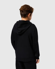 A young person with short, brown hair is seen from behind, wearing a Psycho Bunny KIDS LEVY ZIP FLEECE HOODIE - B0H720D200 made from 100% cotton French terry and black pants. The background is plain white.